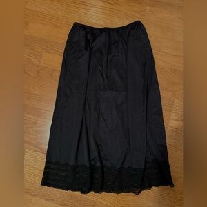 Mid-length black lace skirt